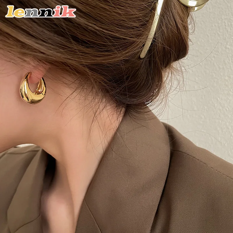 Oval Earrings with Sculpted Metal Design
